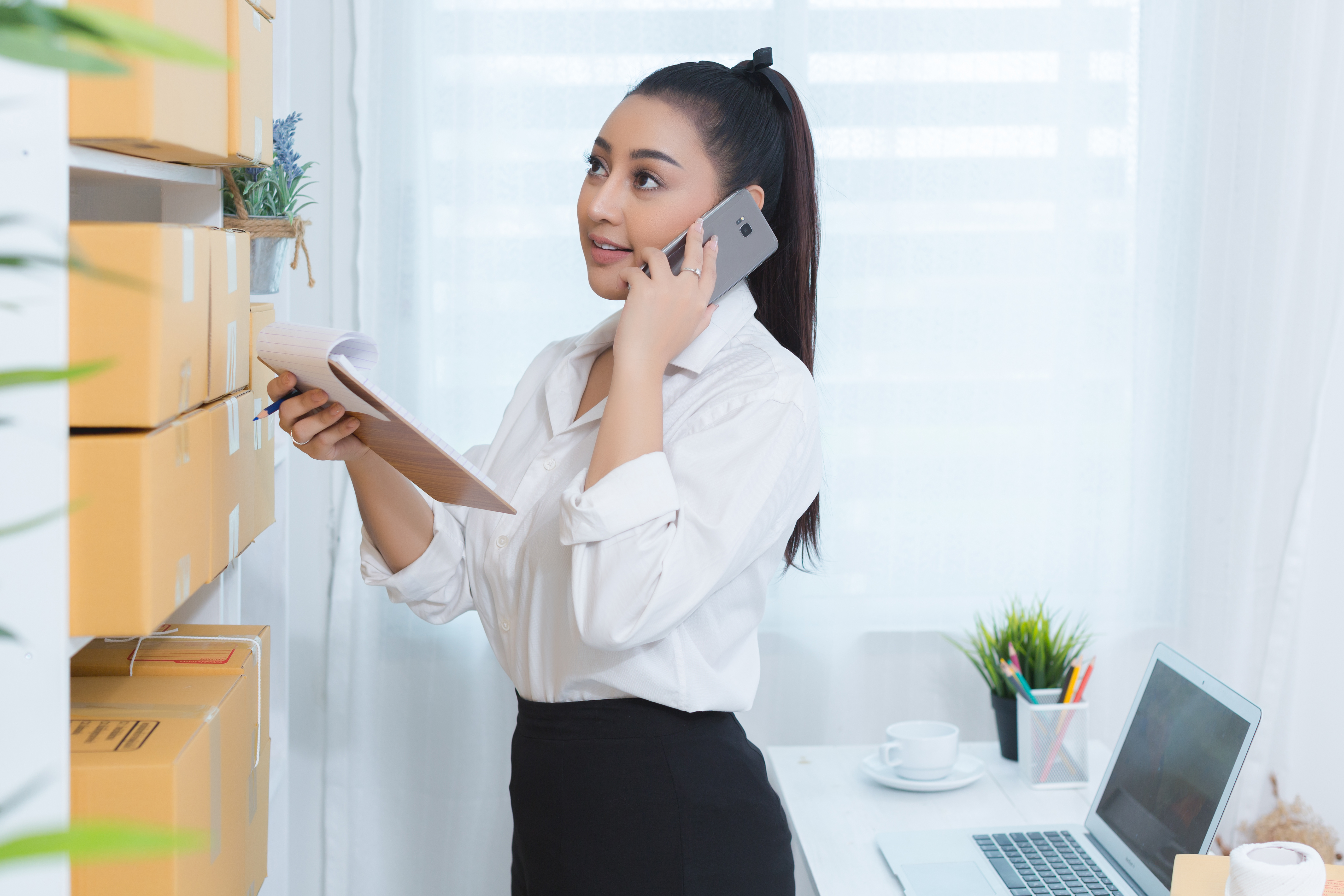 business owner working at home office packaging on background. online shopping SME entrepreneur working Young Women happy after new order from customer.